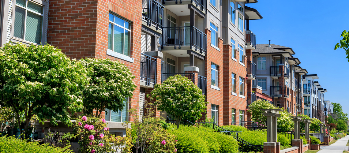 Photograph showing the façade of a multifamily residential building. Photograph showing the façade of a multifamily residential building.