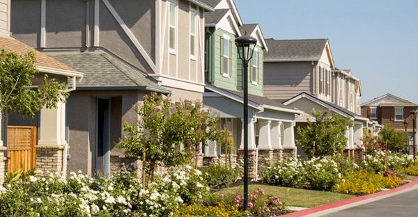 Image of detached single-family homes on a street. Image of detached single-family homes on a street.