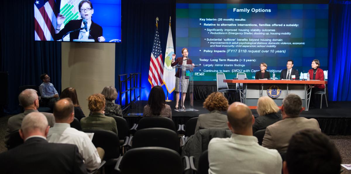 Photograph of Assistant Secretary for Policy Development and Research Katherine O’Regan discussing the impacts of the Family Options Study at the latest PD&R Quarterly Update. Photograph of Assistant Secretary for Policy Development and Research Katherine O’Regan discussing the impacts of the Family Options Study at the latest PD&R Quarterly Update.