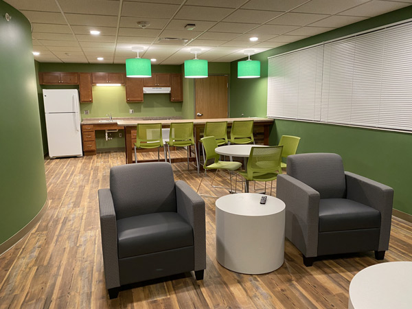 Image of an apartment common room with a kitchen. Image of an apartment common room with a kitchen.