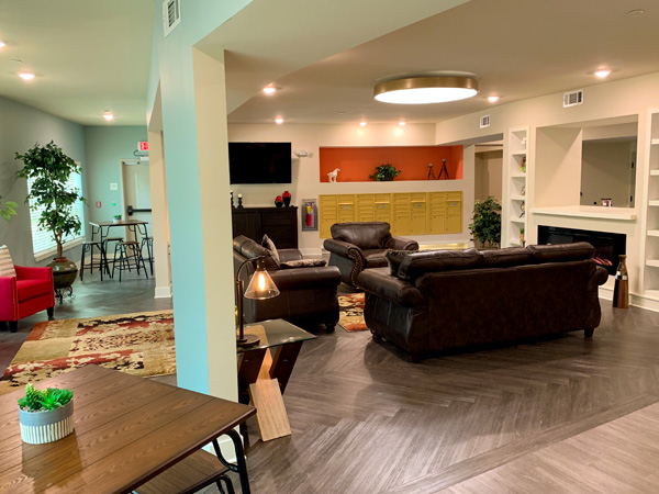 Image of an apartment building’s common lounge area.