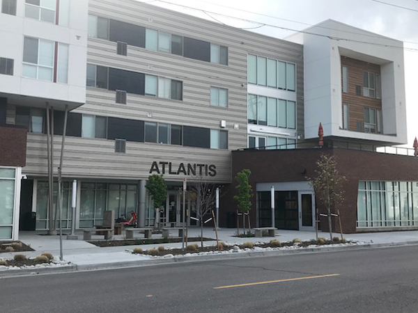 Photograph of the entrance to The Atlantis Apartments with a view of the street in the foreground and the building in the background. Photograph of the entrance to The Atlantis Apartments with a view of the street in the foreground and the building in the background.