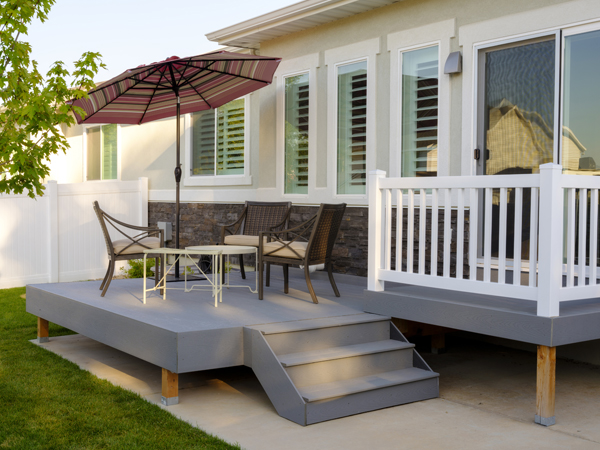 Photo of the backyard and patio of a house. Photo of the backyard and patio of a house.