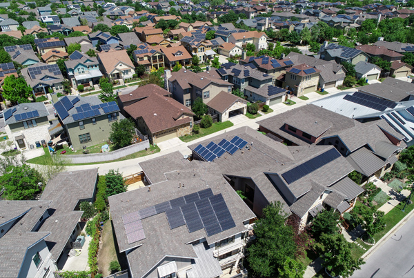  Photo of housing with solar panel rooftops.