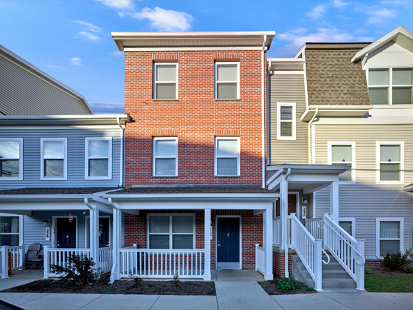 Image of three rowhouses with brick and clapboard exteriors. Image of three rowhouses with brick and clapboard exteriors.