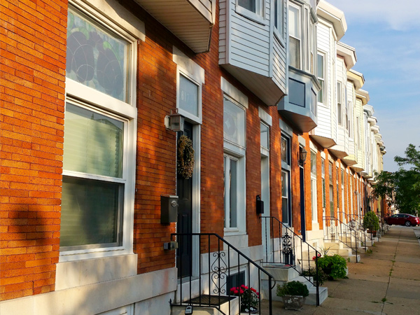 Photo of a row of townhouses in a residential neighborhood.